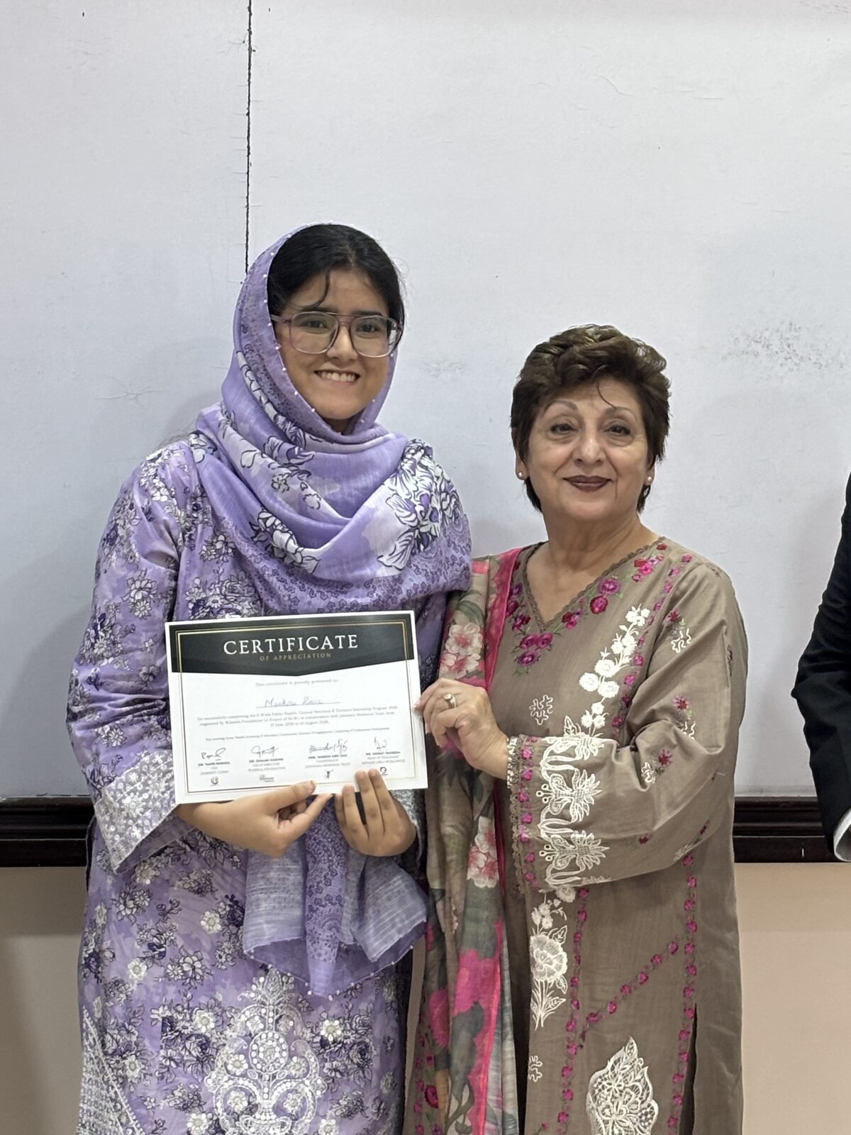 A participant receives her Public Health Nutrition certificate